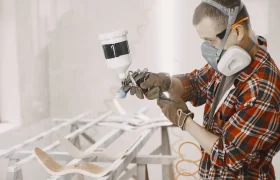 master-painter-factory-painting-wood-with-spray-gun_1157-45896